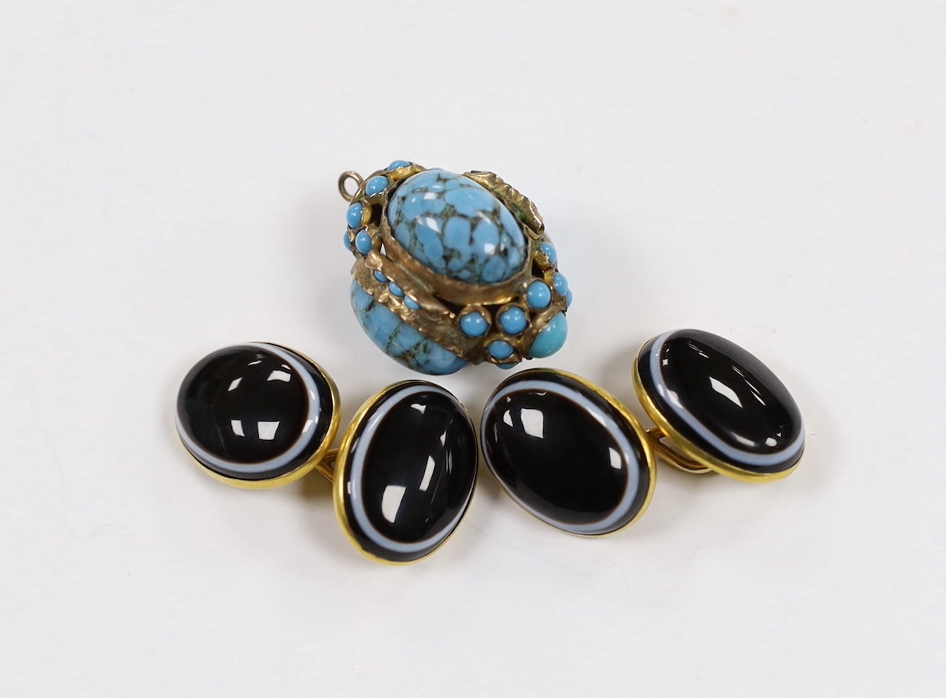 A pair of early 20th century yellow metal (stamped 15) and oval banded agate cufflinks and a yellow metal and turquoise cluster set pendant.